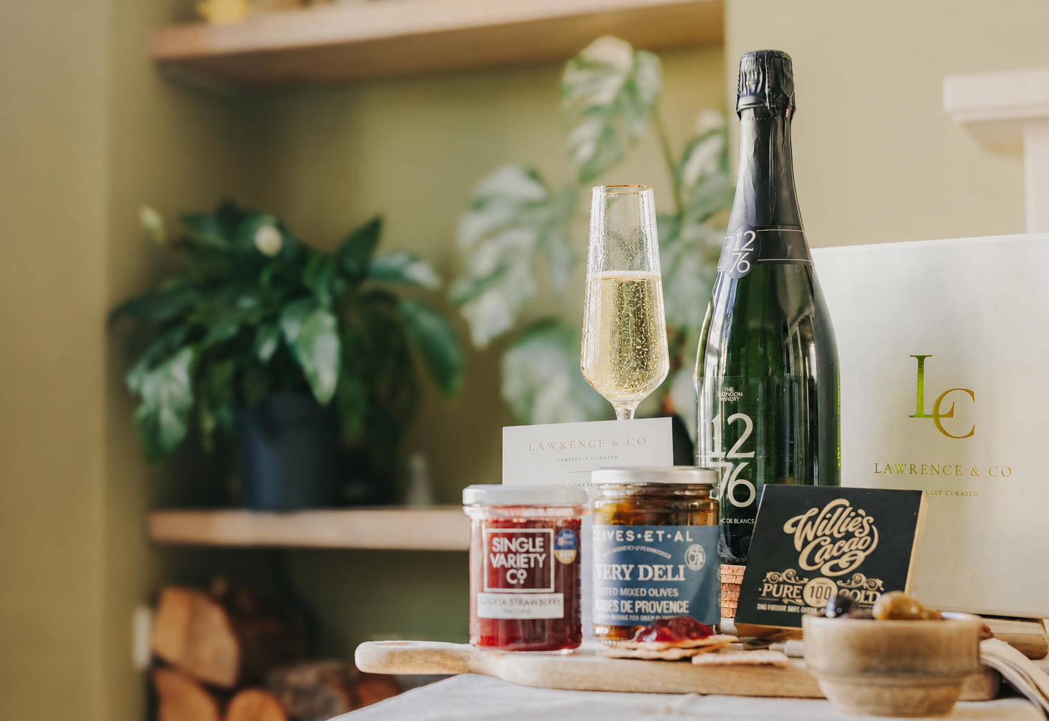 English Blanc de Blancs, a glass of sparkling wine and Lawrence & Co. hamper products
